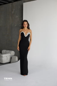 Albina Dyla Serpent Curve strapless black gown with gemstone embellishments, corset bodice, and lace-up back — figure-hugging evening dress from Tenn Designer Hire.