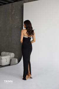 Albina Dyla Serpent Curve strapless black gown with gemstone embellishments, corset bodice, and lace-up back — figure-hugging evening dress from Tenn Designer Hire.
