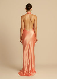 Arcina Ori Gaia Dress Hire in papaya – bias-cut gown with cowl neckline and low open back.