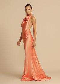 Arcina Ori Gaia Dress Hire in papaya – bias-cut gown with cowl neckline and low open back.