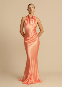Arcina Ori Gaia Dress Hire in papaya – bias-cut gown with cowl neckline and low open back.