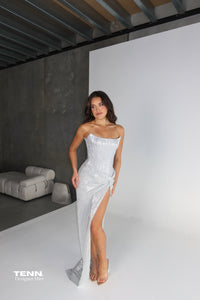 Chanel Gown by Lia Stublla Hire in Diamond – Two-Piece with Crescent Neckline, Fully Boned Corset Bodice, Lace-Up Back, Twist-Detail Skirt, and Thigh-High Split.