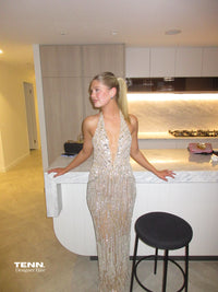 Albina Dyla Stardust Cascade Gown – plunging halter neckline gown with silver bead embellishments, corseted fit, and back leg slit. Hire from Tenn Designer Hire.