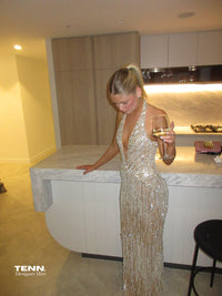 Albina Dyla Stardust Cascade Gown – plunging halter neckline gown with silver bead embellishments, corseted fit, and back leg slit. Hire from Tenn Designer Hire.