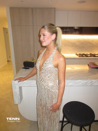 Albina Dyla Stardust Cascade Gown – plunging halter neckline gown with silver bead embellishments, corseted fit, and back leg slit. Hire from Tenn Designer Hire.