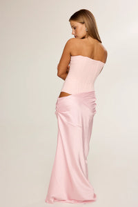HNTR The Label Huxley Gown in pink available for hire at TENN Designer Hire — chic two-piece gown featuring a strapless neckline, longline corset bodice, and flowing silky skirt designed for the ultimate cool-girl look.