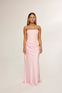 HNTR The Label Huxley Gown in pink available for hire at TENN Designer Hire — chic two-piece gown featuring a strapless neckline, longline corset bodice, and flowing silky skirt designed for the ultimate cool-girl look.