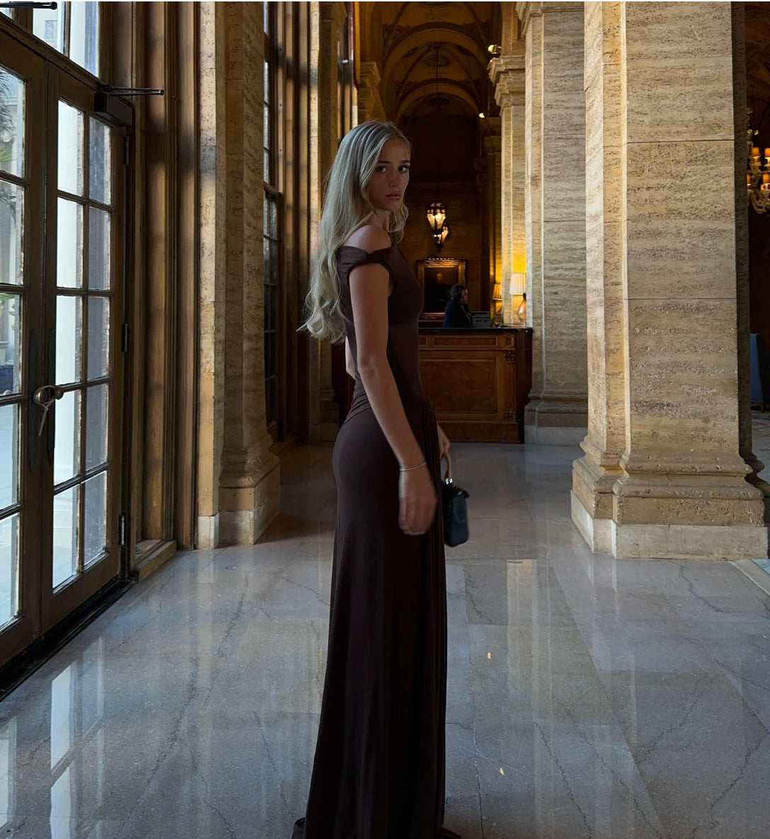 Misha Collection Sisal Mesh Maxi Dress available for hire at TENN Designer Hire — timeless and daring gown with asymmetric neckline, twist detail, sheer bodice, and flowing silhouette, perfect for day-to-night events.