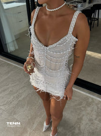 Pearl-embellished mini dress with corset bodice and open back.