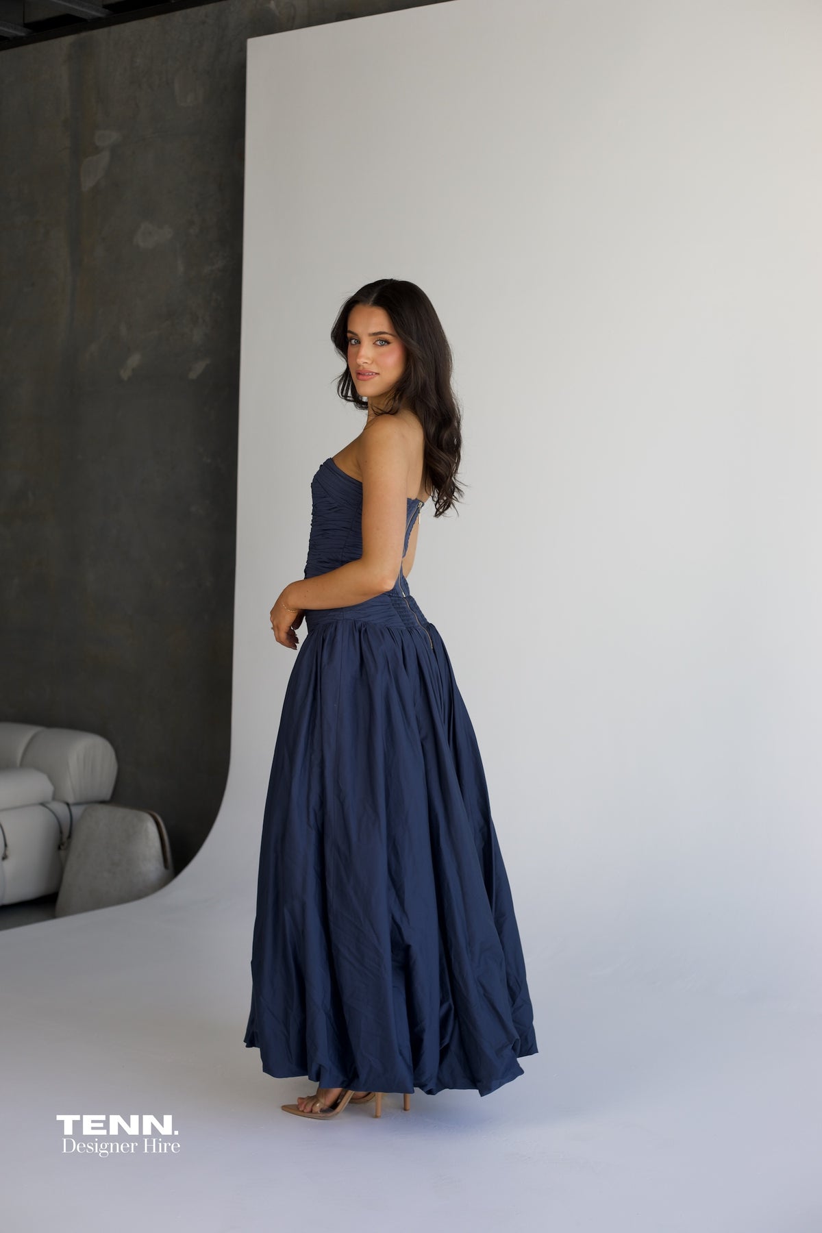 Aje Violette Bubble Hem Maxi Dress in slate available for hire at TENN Designer Hire — two-piece formal gown featuring Sunbeam bustier and Violette bubble hem skirt, thigh-high slit, figure-hugging corset bodice, and elegant dropped waist.