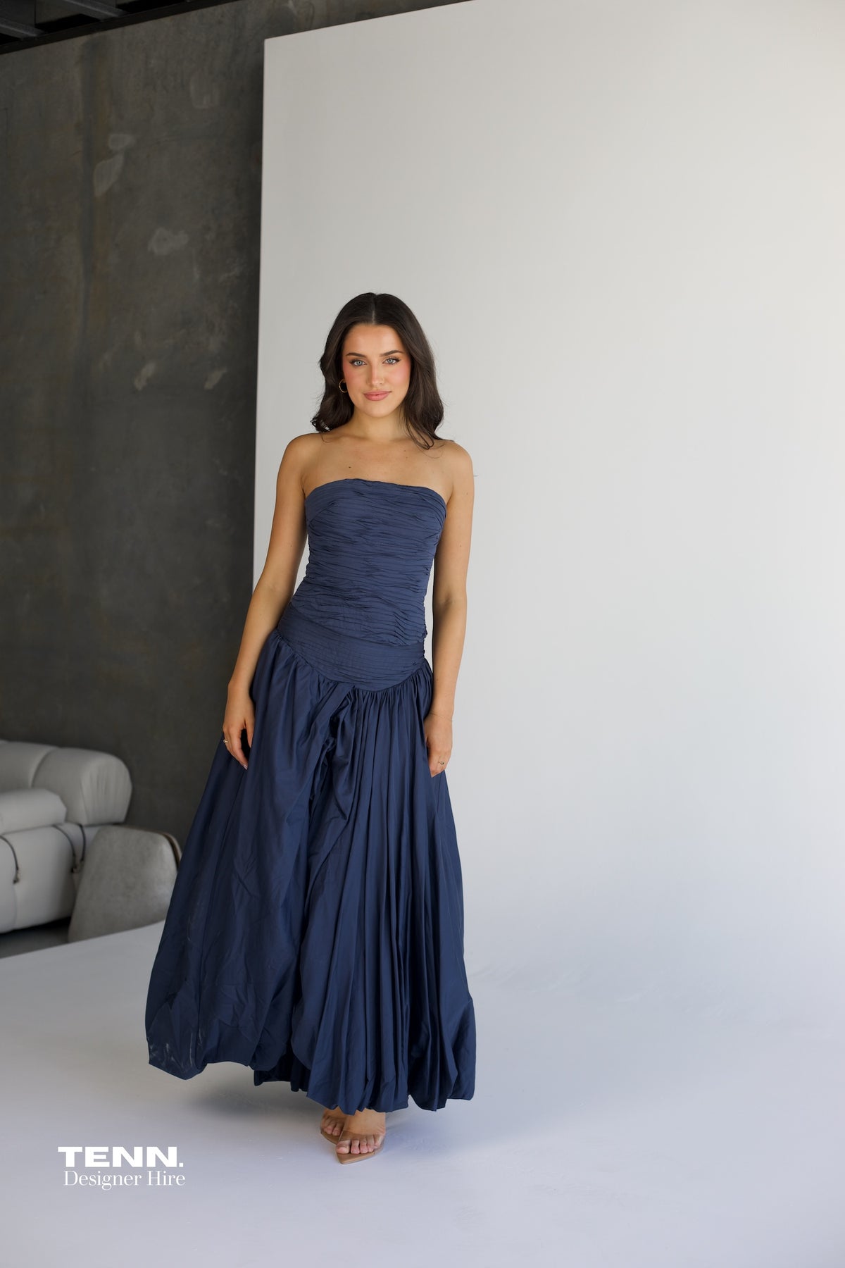 Aje Violette Bubble Hem Maxi Dress in slate available for hire at TENN Designer Hire — two-piece formal gown featuring Sunbeam bustier and Violette bubble hem skirt, thigh-high slit, figure-hugging corset bodice, and elegant dropped waist.