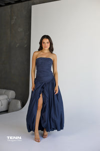 Aje Violette Bubble Hem Maxi Dress in slate available for hire at TENN Designer Hire — two-piece formal gown featuring Sunbeam bustier and Violette bubble hem skirt, thigh-high slit, figure-hugging corset bodice, and elegant dropped waist.