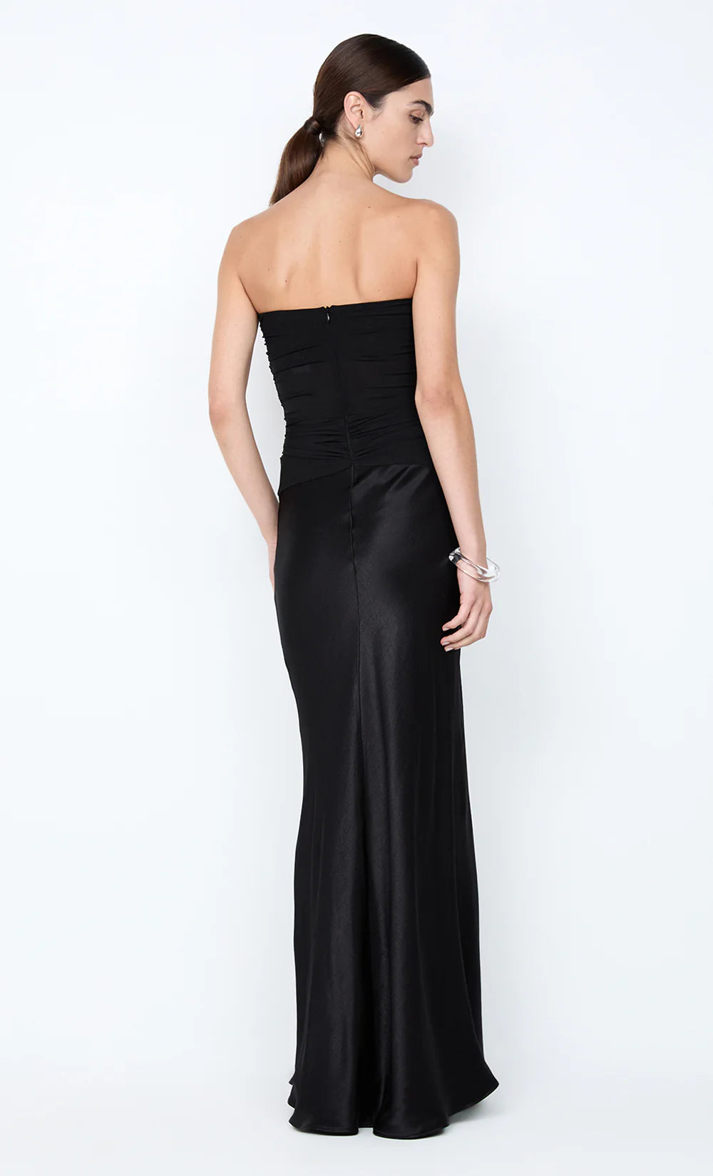 Bec and Bridge Millah Black Strapless Maxi Dress available for hire at TENN Designer Hire — chic and feminine gown with a strapless neckline, pinched waist detailing, and silky skirt that creates an elegant, effortless silhouette.