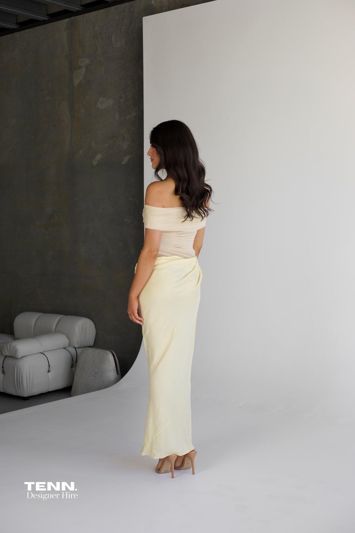 Benni Nico Maxi Dress available for hire at TENN Designer Hire — effortlessly chic summer dress with off-shoulder neckline and asymmetric skirt, perfect for long lunches, summer nights, and special occasions.