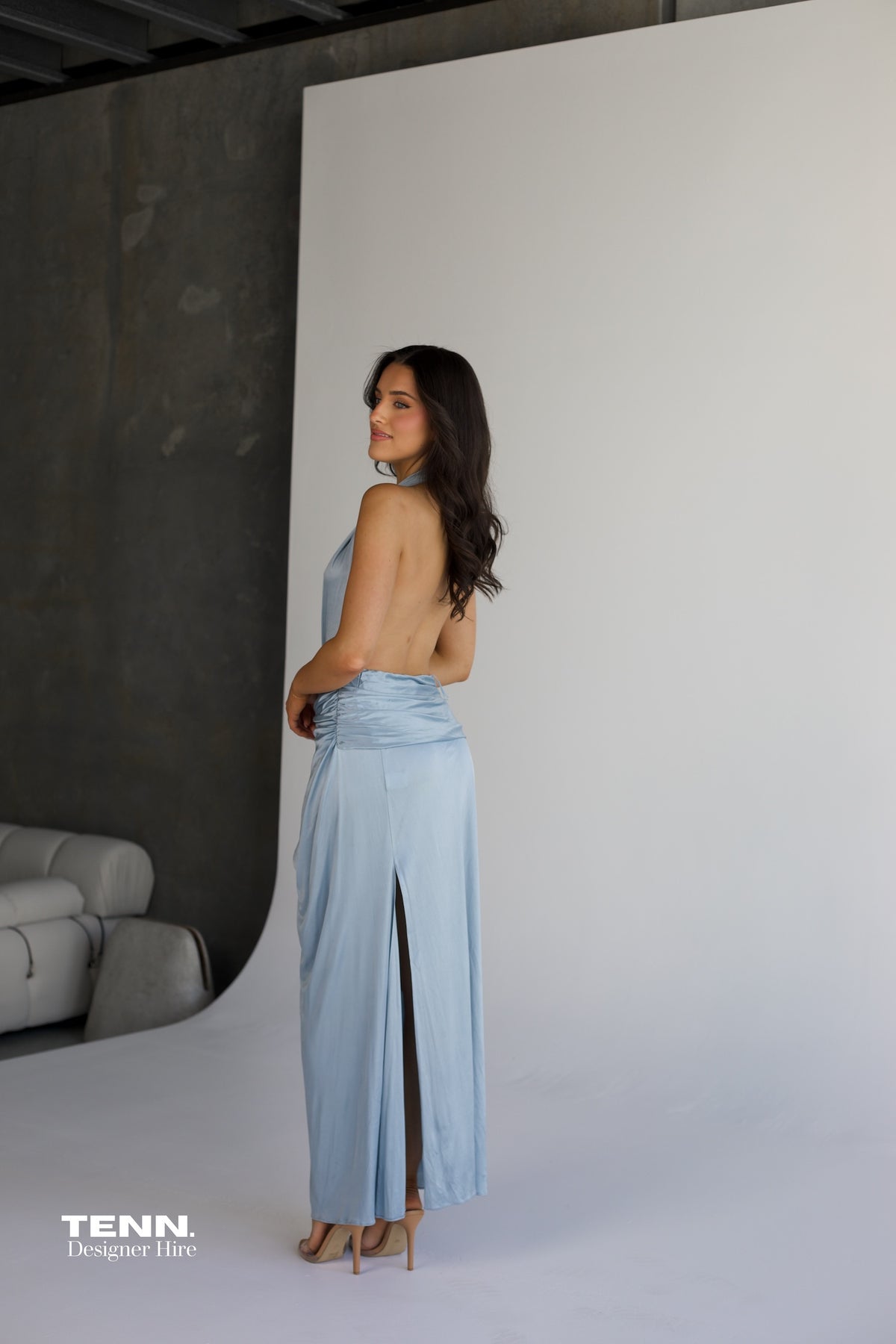 Courtney Zheng Selene Plunge Jersey Gown in sky blue available for hire at TENN Designer Hire — silky fluid gown with deep plunging neckline, open back, gathered waist, and high slit, perfect for formal events and red carpet occasions.