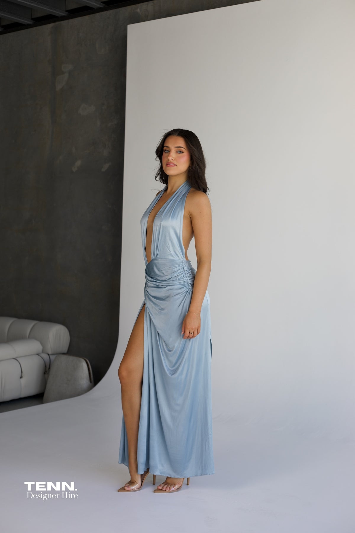 Courtney Zheng Selene Plunge Jersey Gown in sky blue available for hire at TENN Designer Hire — silky fluid gown with deep plunging neckline, open back, gathered waist, and high slit, perfect for formal events and red carpet occasions.
