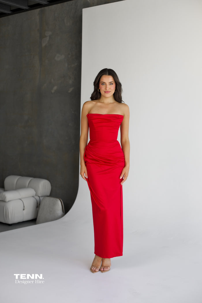 House of CB Adrienne Strapless Corset Dress available for hire at TENN Designer Hire — elegant pointed neckline gown with structured corset bodice, pleated hip detailing, and figure-enhancing silhouette, perfect for formal occasions.