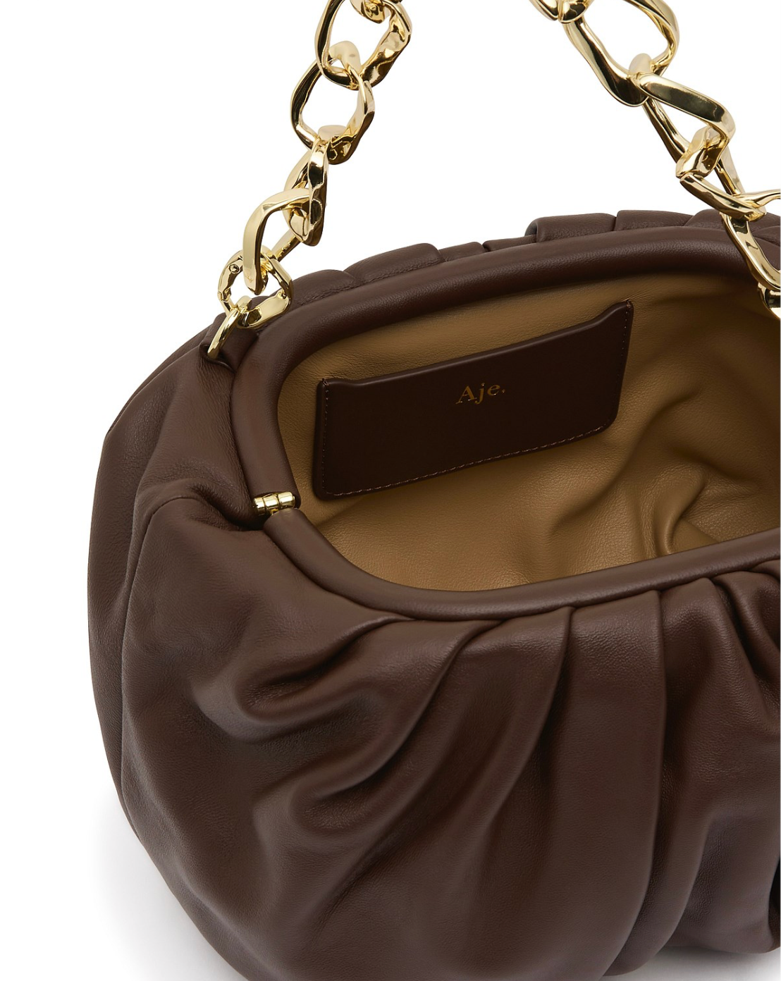 Aje Arden Clutch in brown leather with organic link hardware detailing, luxury designer bag available for hire from TENN Designer Hire.